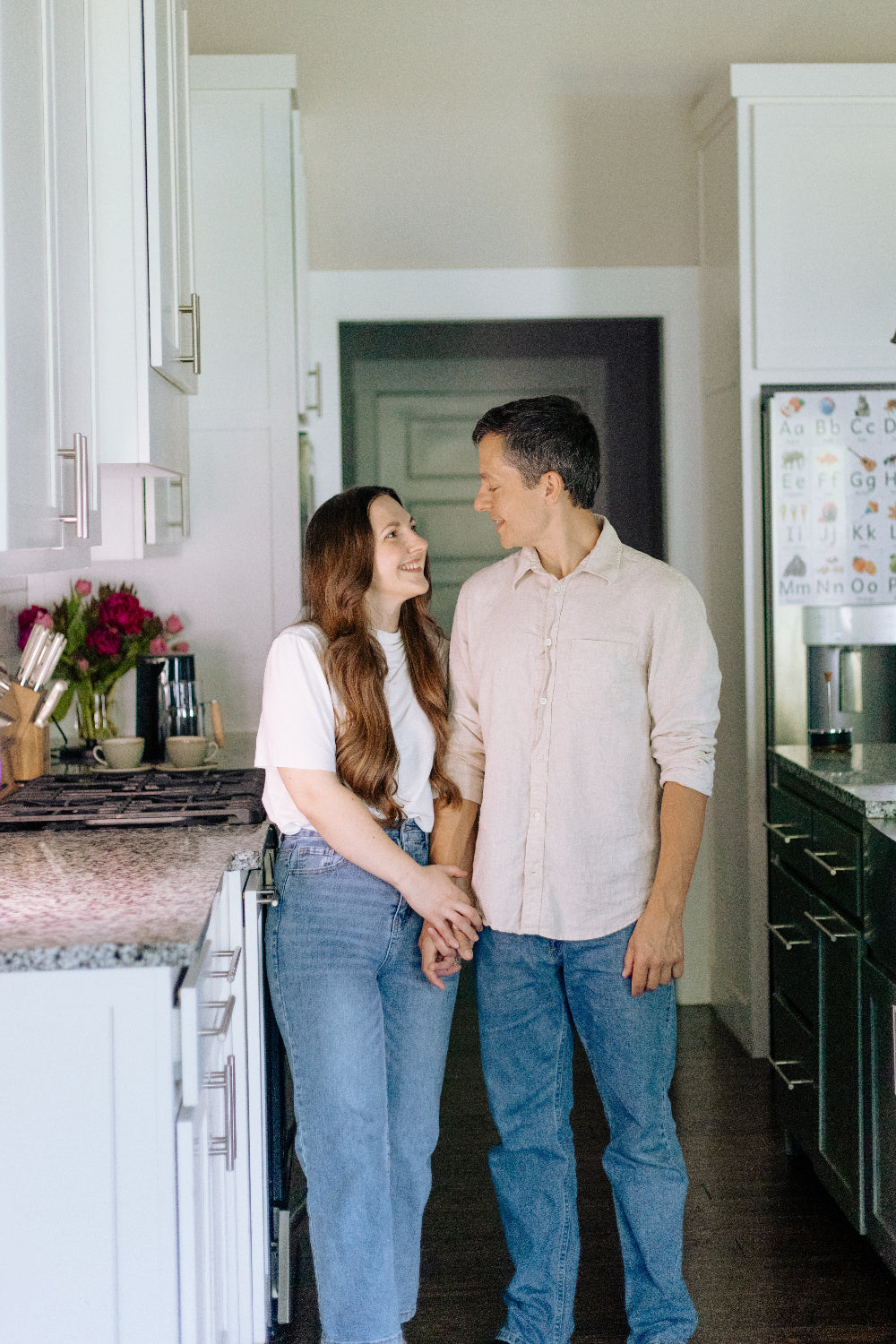Couple holding hands in a kitchen