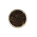 Everlastea Organic black mango loose leaf tea in a glass bowl.