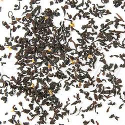 Close-up of black tea leaves on a white background