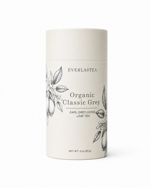 A tall, cylindrical white container of Everlastea Organic Classic Grey leaf tea, featuring black text and delicate botanical illustrations on the front label, set against a clean white background.