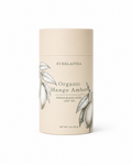 A cylindrical cardboard canister of Everlastea Organic Mango Amber leaf tea, featuring a light beige label with botanical illustrations of mango leaves and a clean white background.