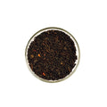 Everlastea Organic wild berry black loose leaf tea in a glass bowl.